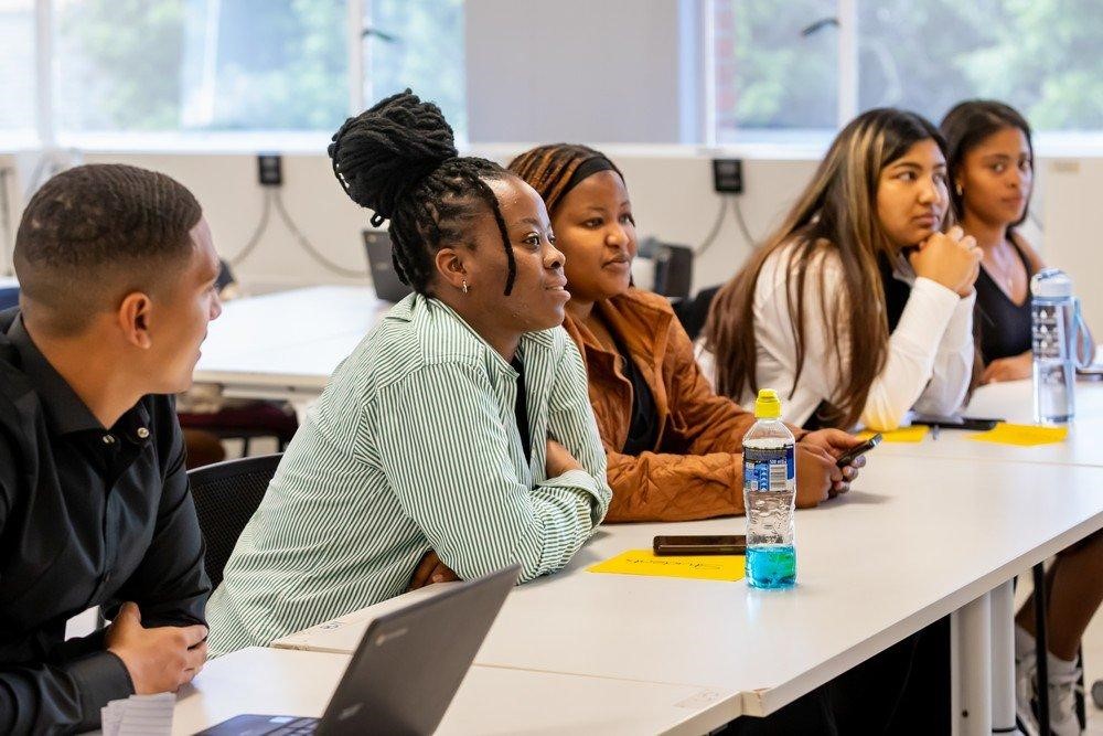 Students participating in a university classroom